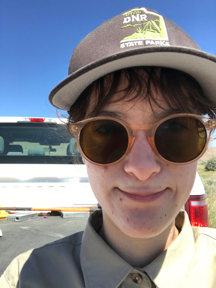 Close-up of Hannah's face with an Antelope Island State Park hat.