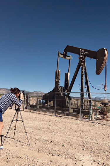 Alisha filming an oil rig