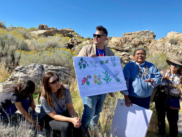 Shoshone leaders display illustrations of plants while talking about Shoshone history at Antelope Island.