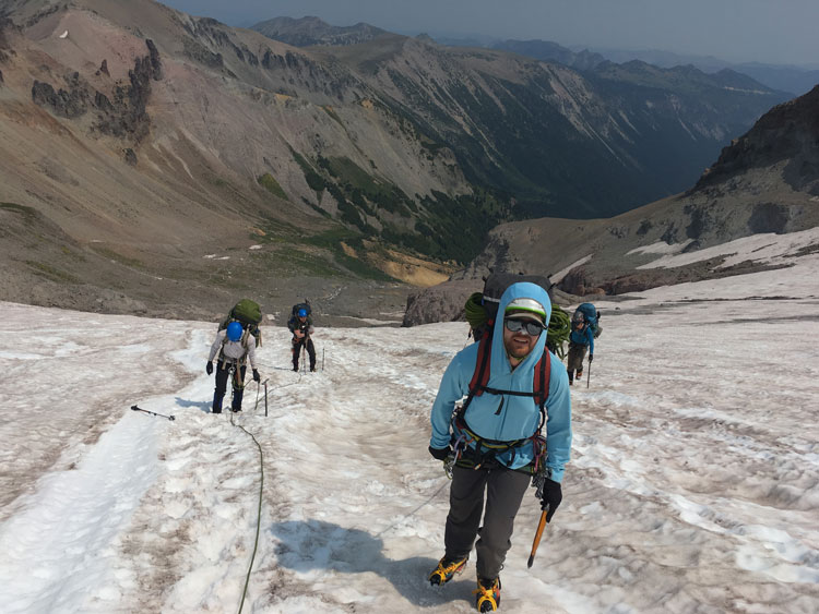 Jeff Rose hiking with a group up a snow field