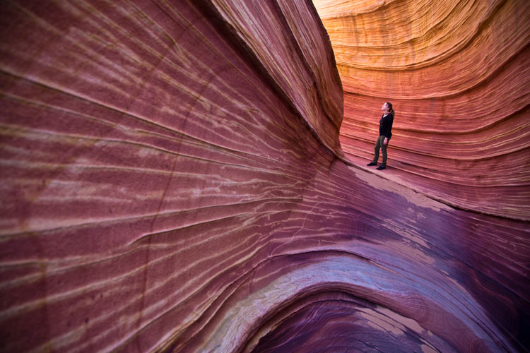 Morgan stands in a sandstone feature.