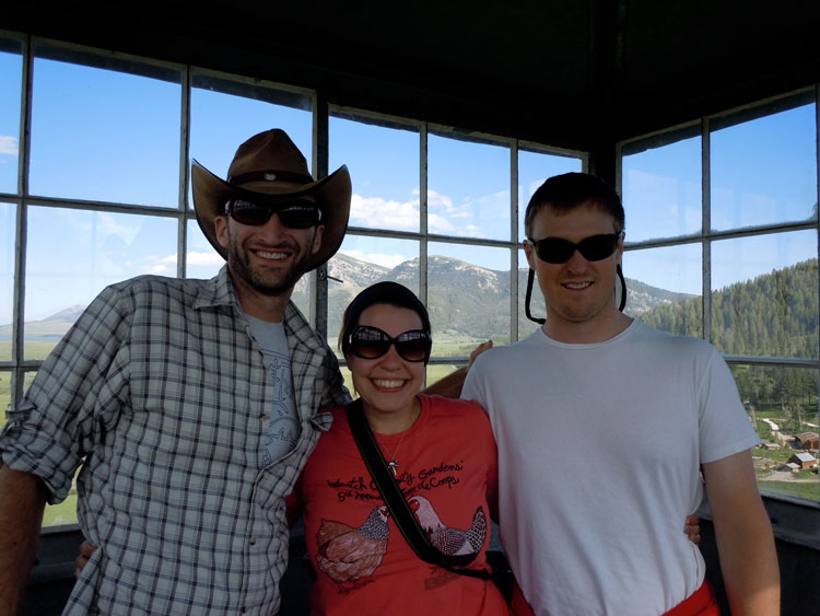 Ross and classmates stand in a fire tower at the Taft Nicholson Center, the view of the Centennial Valley in the distance through the windows.
