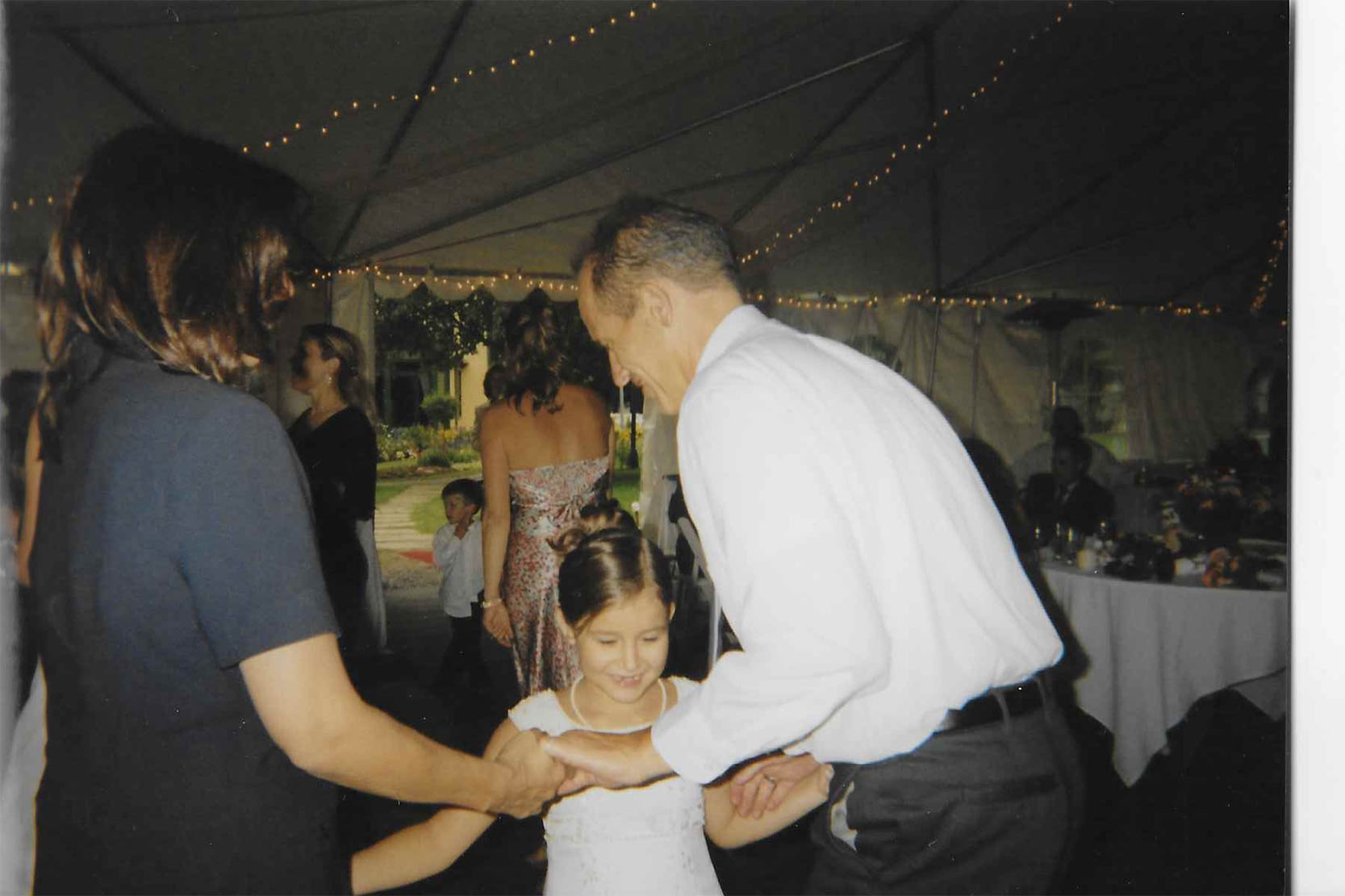 Skylar dancing with her dad and mom at her cousins wedding. 