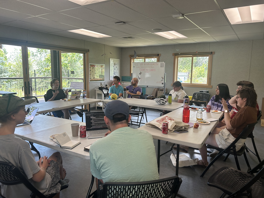 10 person class sitting in a circle at the Nature Center at Pia Okwai. 