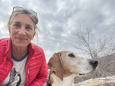 Cory Pike in a red jacket with her dog hound. 